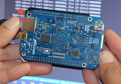 This image has an empty alt attribute; its file name is Hands-holding-Micron-board.jpg